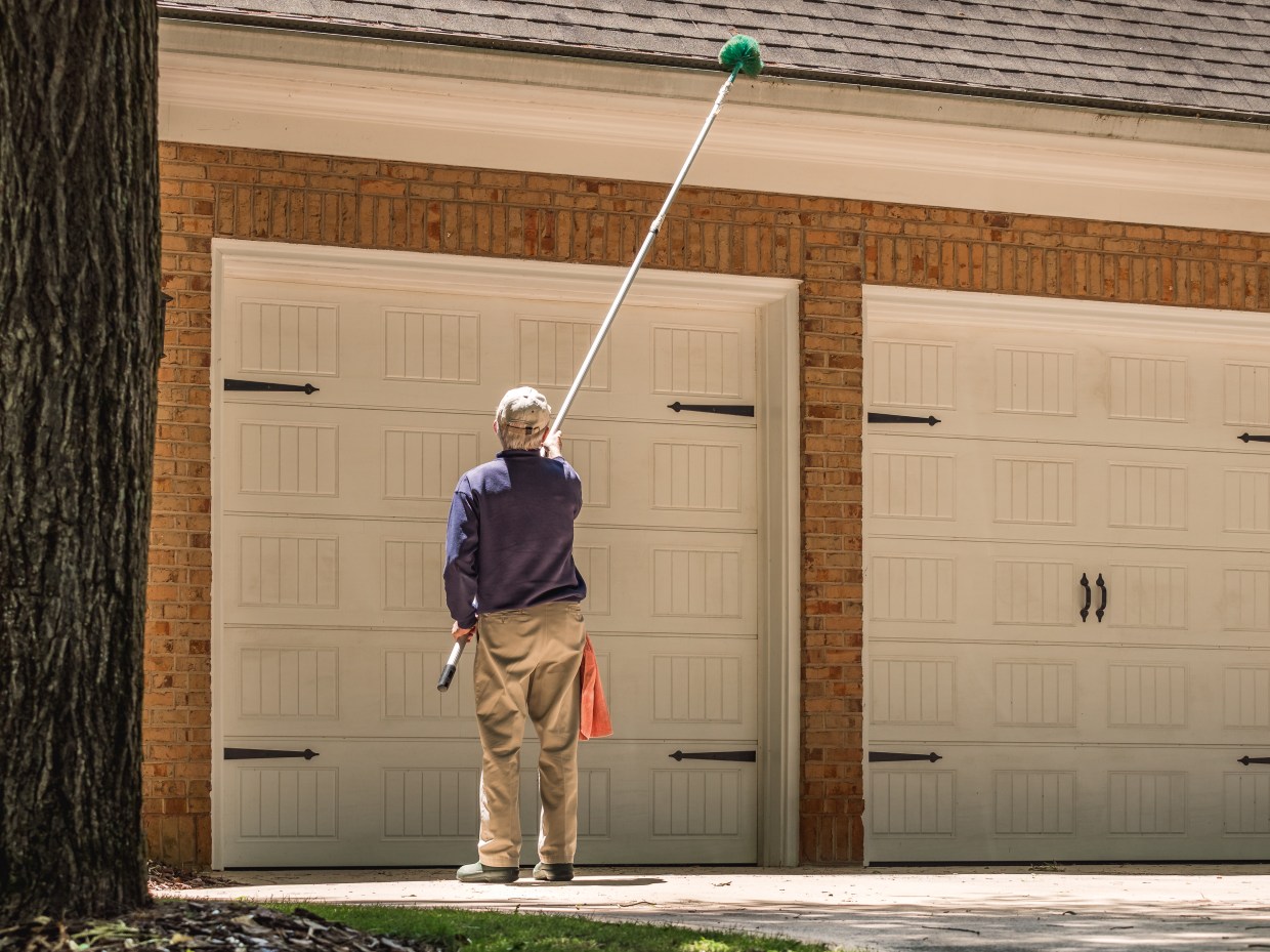 man cleaning gutter